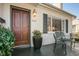 Welcoming front porch features a dark wood door, classic lighting, and ample space for seating at 229 Gordon St, Charleston, SC 29403