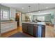 Modern kitchen with a large island, stainless steel appliances, and hardwood floors throughout at 229 Gordon St, Charleston, SC 29403
