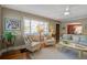 Bright living room features a ceiling fan, and hardwood floors, with large windows offering natural light at 229 Gordon St, Charleston, SC 29403