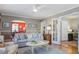 Open-concept living room showing hardwood floors, neutral decor, and archway to dining room with a chandelier at 229 Gordon St, Charleston, SC 29403