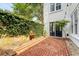 Picturesque backyard with brick patio, serene fountain, and lush, verdant greenery at 23 Felix St, Charleston, SC 29403
