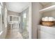 Bright bathroom with glass shower, dual pedestal sinks, storage space with towels, and tiled floors at 23 Felix St, Charleston, SC 29403