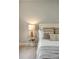 Close up of a bed with pillows and a side table with a lamp in a light and airy space at 23 Felix St, Charleston, SC 29403