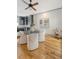 Well-lit dining area features wood floors, modern furnishings, and an eye-catching art piece at 23 Felix St, Charleston, SC 29403