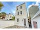 Charming three-story home with white siding, multiple windows and private fenced patio at 23 Felix St, Charleston, SC 29403