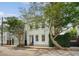 Charming two-story home with a blue front door and mature trees in a desirable neighborhood at 23 Felix St, Charleston, SC 29403