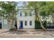 Charming two-story home with a blue front door and beautiful trees in a desirable neighborhood at 23 Felix St, Charleston, SC 29403