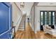 Bright, inviting foyer with hardwood floors, staircase, and access to the living spaces at 23 Felix St, Charleston, SC 29403