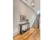 Elegant foyer with hardwood floors, a staircase, stylish lighting, and sophisticated decor at 23 Felix St, Charleston, SC 29403
