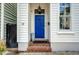 Inviting entryway featuring a vibrant blue front door, brick steps, and classic architectural details at 23 Felix St, Charleston, SC 29403