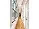Bright hallway with wood flooring, large windows, and classic white trim and doors at 23 Felix St, Charleston, SC 29403