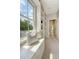 Hallway with built-in bookshelves, bench seat and a window, leading to a tiled bathroom at 23 Felix St, Charleston, SC 29403
