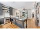 Spacious open concept kitchen with a center island, fireplace and view into the dining area with table and chairs at 23 Felix St, Charleston, SC 29403