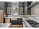 Kitchen featuring sleek appliances, white tile backsplash, and ample cabinet space at 23 Felix St, Charleston, SC 29403
