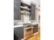 Modern kitchen boasts stainless steel range, oven, gray cabinets and open shelving with white subway tile backsplash at 23 Felix St, Charleston, SC 29403
