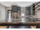 Modern kitchen featuring dark cabinets, stainless steel appliances, and a unique island counter at 23 Felix St, Charleston, SC 29403