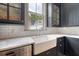 Bright kitchen features stainless steel appliances, farmhouse sink, white subway tile backsplash and marble countertops at 23 Felix St, Charleston, SC 29403
