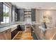 Open-concept kitchen with stainless steel appliances, marble counters, gray cabinets, and a large metal kitchen island at 23 Felix St, Charleston, SC 29403