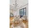 Elegant living room with chandelier, wood floors, and french doors to patio at 23 Felix St, Charleston, SC 29403