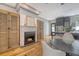 Inviting living room with a charming fireplace, wood floors, and a stylish dining area at 23 Felix St, Charleston, SC 29403