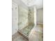 Modern glass-enclosed shower with tiled walls, multiple shower heads, and travertine flooring at 23 Felix St, Charleston, SC 29403