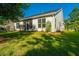 Well-maintained backyard with a screened porch, mature trees, and lush green grass, ideal for outdoor living and entertaining at 2314 Hummingbird Ln, Summerville, SC 29483
