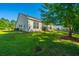 Spacious backyard with a well-kept lawn, mature trees, and tidy landscaping, creating a private and serene outdoor space at 2314 Hummingbird Ln, Summerville, SC 29483