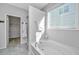 Relaxing soaking tub, separate shower, and ample natural light highlight the elegant bathroom at 2314 Hummingbird Ln, Summerville, SC 29483