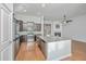 Open kitchen features granite counters, stainless appliances, and a view to the living room fireplace at 2314 Hummingbird Ln, Summerville, SC 29483