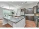 Bright kitchen features a large island with granite countertop, stainless appliances, and ample cabinet space at 2314 Hummingbird Ln, Summerville, SC 29483