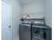 Well-equipped laundry room with washer, dryer, and wire shelving for storage at 2314 Hummingbird Ln, Summerville, SC 29483