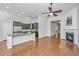 Open-concept living area featuring hardwood floors, a fireplace, and a kitchen with a center island at 2314 Hummingbird Ln, Summerville, SC 29483