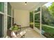 Cozy screened porch featuring comfortable wicker chairs, perfect for enjoying the outdoors in comfort and style at 2314 Hummingbird Ln, Summerville, SC 29483