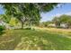 Expansive backyard featuring lush lawn, mature trees, and serene canal frontage at 2525 Bent Tree Ln, Mount Pleasant, SC 29464