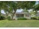 Charming backyard featuring a screened porch, a beautiful lawn, and mature trees at 2525 Bent Tree Ln, Mount Pleasant, SC 29464