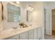 Bright bathroom featuring a double vanity with white cabinets and marble countertops at 2525 Bent Tree Ln, Mount Pleasant, SC 29464