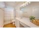 Bright bathroom featuring a vanity with white cabinets, marble countertops and a shower at 2525 Bent Tree Ln, Mount Pleasant, SC 29464