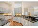Well-lit kitchen featuring granite countertops, white cabinets, and hardwood floors at 2525 Bent Tree Ln, Mount Pleasant, SC 29464