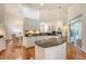 Open kitchen layout with granite countertops, white cabinets, and a kitchen island, flowing into dining area at 2525 Bent Tree Ln, Mount Pleasant, SC 29464