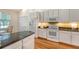 Bright kitchen showcasing white appliances, granite countertops, and hardwood floors at 2525 Bent Tree Ln, Mount Pleasant, SC 29464