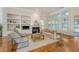 Bright and airy living room with hardwood floors, built-in shelves, fireplace and large windows at 2525 Bent Tree Ln, Mount Pleasant, SC 29464