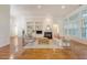 Bright living room with hardwood floors, a fireplace, and custom built-in shelving, open layout and many windows at 2525 Bent Tree Ln, Mount Pleasant, SC 29464
