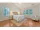 Bright main bedroom offers a ceiling fan, hardwood floors, and large windows at 2525 Bent Tree Ln, Mount Pleasant, SC 29464