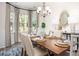 Formal dining room with wood table, stylish chandelier, and bay window with natural light at 259 Camellia Bloom Dr, Moncks Corner, SC 29461
