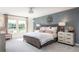 Serene main bedroom with accent wall, plush bedding, and plenty of natural light at 259 Camellia Bloom Dr, Moncks Corner, SC 29461