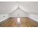 An interior shot of a bonus attic space featuring hardwood floors, a single window, and neutral walls at 272 Coming St # C, Charleston, SC 29403