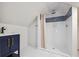 An open shot of a white bathroom with a navy blue vanity and a shower with white subway tiles at 272 Coming St # C, Charleston, SC 29403
