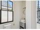 Cozy powder room featuring a pedestal sink, stylish fixtures, and natural light at 272 Coming St # C, Charleston, SC 29403