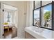 Bright bathroom featuring a modern sink, brass faucet, and a view into an adjacent bedroom at 272 Coming St # C, Charleston, SC 29403