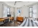 Bright bedroom with hardwood floors, three large windows, and classic furnishings at 272 Coming St # C, Charleston, SC 29403